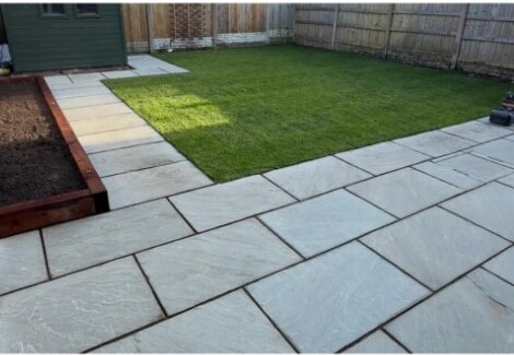 Fresh lawn with a new paved patio
